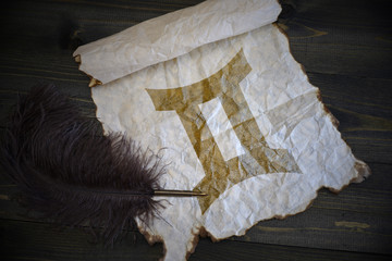 Gemini sign of the zodiac on vintage paper with old pen on the wooden texture desk