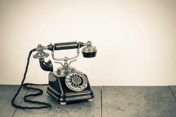Fototapete - Vintage background with old rotary telephone on wood table