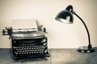Vintage old typewriter, and lighting retro desk lamp on wood table