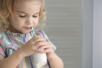 Poster - Cute little girl drinking yogurt at home