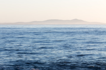 An empty body of ocean and a distant land mass on the east coast of Australia.