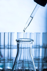 Wall Mural - dropping chemical liquid to test tubes