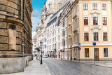 Fototapeta Uliczki - A narrow street in the historic center of Dresden in the morning without pedestrians and cars