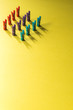 Colorful laundry clips on yellow background. 