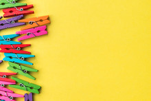 Colorful Laundry Clips On Yellow Background. 