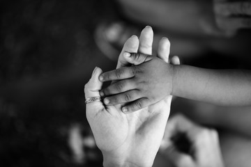 Hands of child and adult. Black and white hand. Trust and support, motherhood and childhood, parent and son or daughter. Children of Africa. Family and love between mother and child