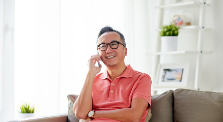 Canvas Print - happy man calling on smartphone at home