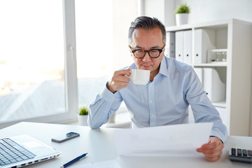 Sticker - businessman with papers drinking coffee at office