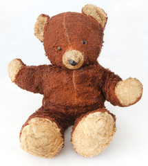 Old, worn, threadbare vintage 1940s teddy bear. Isolated.