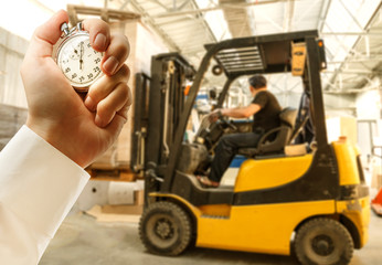 Paper products storehouse driver and stopwatch in hand