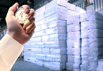 Paper products storehouse and stopwatch in hand