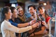 © WavebreakMediaMicro - Cheerful friends toasting beer bottles