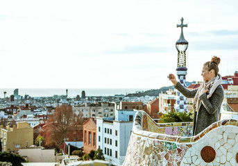 traveller woman in Barcelona taking photo with digital camera