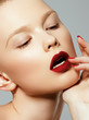 © looking2thesky - Beauty woman Face. Portrait of beautiful sexy young female with perfect matte facial makeup. Soft healthy skin. Glamorous girl on gray background. Red lips