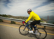 © Erik Isakson/Blend Images - Hispanic man riding bicycle on waterfront road