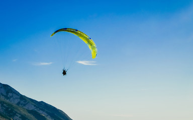 Paragliding tandem flying over the mountains. Freedom concept