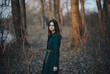 © Dmitry Ageev/Blend Images - Caucasian woman standing near trees and river