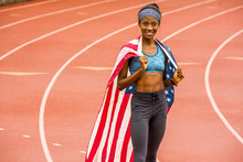 Smiling Black Athlete Posing With American Flag On Track