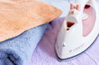 © 279photo - Pile of colorful towels with iron in laundry fabric background