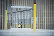 © Erik Isakson/Blend Images - Workers with boxes on hand truck in empty warehouse