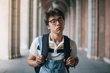 Wall Mural - College student with his backpack serious and tired. Wearing vintage uniform