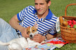 © dream@do - Happy smiling man resting at a picnic in park with a dog Jack russell terrier. Lunch break outdoors , Time for relax, Leisure Lifestyle Concept