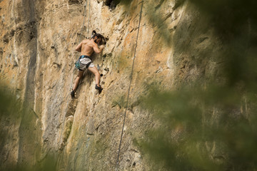 Young man climbing on a wall