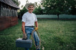 © Inti St Clair/Blend Images - Caucasian farmer carrying rope and toolbox