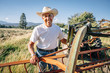 © Inti St Clair/Blend Images - Portrait of Caucasian farmer standing near tractor