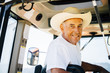 © Inti St Clair/Blend Images - Portrait of smiling Caucasian farmer in tractor