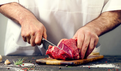 Wall Mural - Chef cutting beef meat