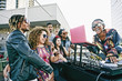 © Peathegee Inc/Blend Images - DJ and young people at rooftop party