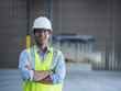 © Erik Isakson/Blend Images - Smiling Indian worker in empty warehouse