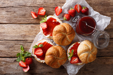 Wall Mural - Sweet sandwiches with strawberry jam, cream cheese and mint closeup. Horizontal top view