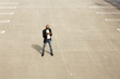 © Adam Hester/Blend Images - Gay Black man texting in empty parking lot