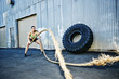 © Peathegee Inc/Blend Images - Mixed Race woman working out with heavy ropes outdoors