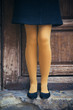 Woman legs over a wooden door wearing yellow panties and ballerinas - Funny tights and flat shoes - Colorful female legs