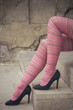Sitting woman on stairs, legs detail, with pink striped panties and black stiletto shoes - Funny tights - Colorful female legs - Fashion, cute, retro stylish look