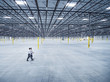 © Erik Isakson/Blend Images - Businessmen walking in empty warehouse