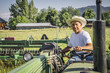 © Inti St Clair/Blend Images - Portrait of Caucasian farmer on tractor