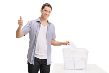 Voter casting vote into ballot box and making thumb up