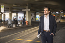 Portrait Of Young Businessman Waiting At Bus Terminal