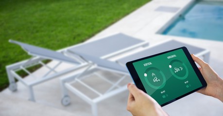 Canvas Print - Hands using smart home application on digital tablet at poolside