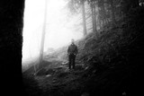 Fototapeta Sawanna - A man stands contentedly in a hazy forest