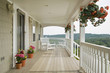 © BUILT Images/Blend Images - Large front porch of shingle style home with great view of tree tops