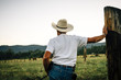 © Inti St Clair/Blend Images - Caucasian farmer leaning on wooden post