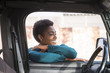 © Fabio Camandona/Blend Images - Smiling African American woman leaning on car window