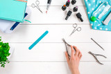 Fototapeta  - Manicure set and nail polish on wooden background