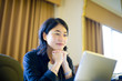 © Jed Share/Kaoru Share/Blend Images - Smiling Japanese businesswoman reading laptop