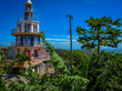Roatan, Honduras Lighthouse building. Landscape of the island with a blue sky and green vegetation in the background.